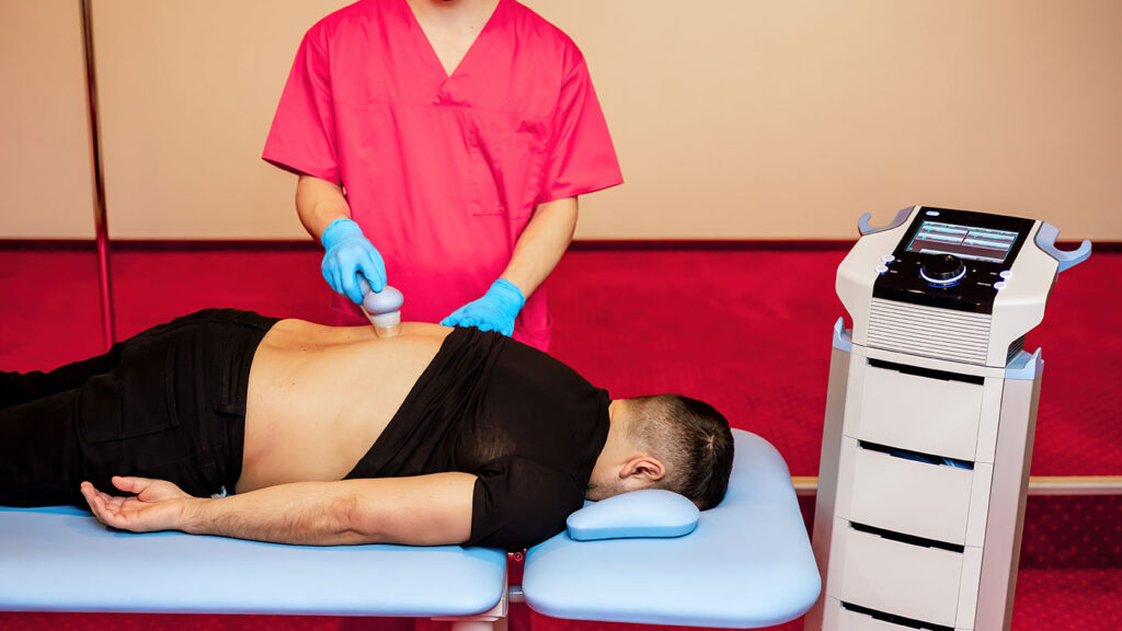 fizioterapeut face procedura de fizioterapie unui varstnic